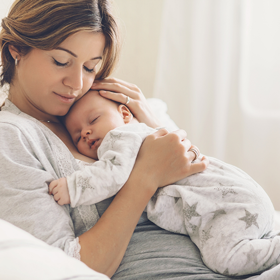 Mother holding her sleeping baby