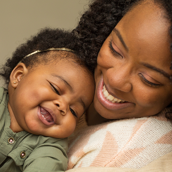 Smiling mother holding her baby