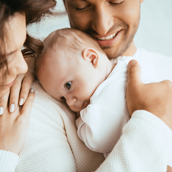 Mother and father holding their baby