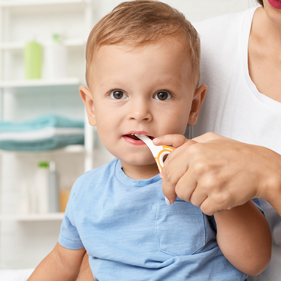 Dentist placing a dental instrument in a childs mouth