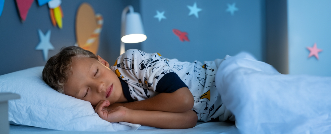 Child sleeping soundly on their side after lip and tongue tie treatment in Boulder