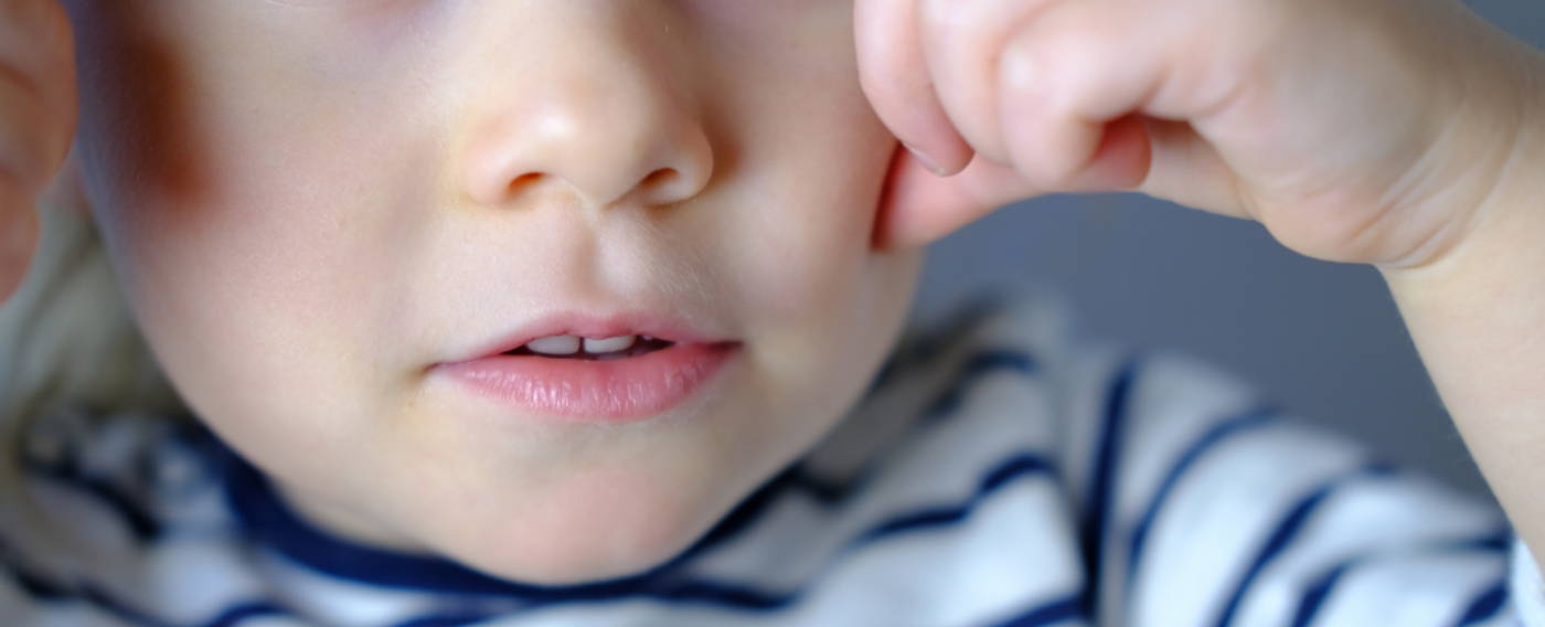 Close up of a child smiling after lip and tongue tie treatment