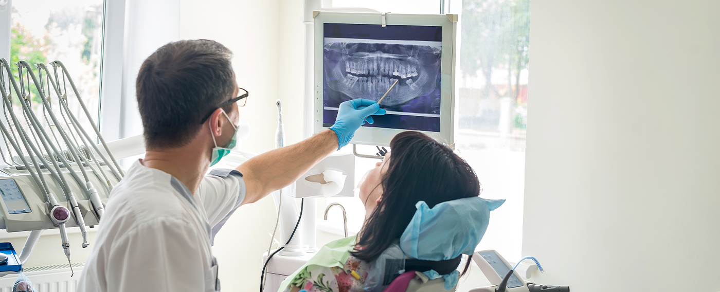 Dentist showing a patient an x ray of their teeth