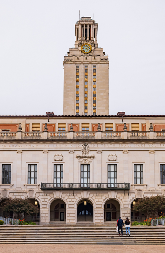 Staircase in front of university building with giant clock tower