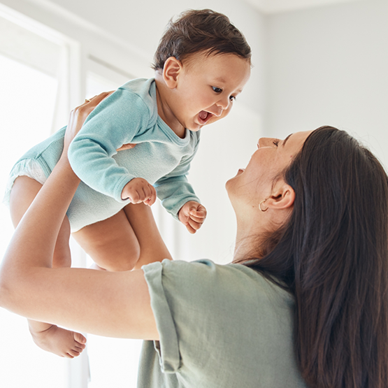 Mother lifting her baby in the air